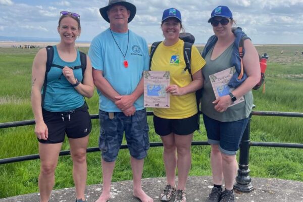 Kings guide Michael wearing blue t-shirt with 3 walkers smiling